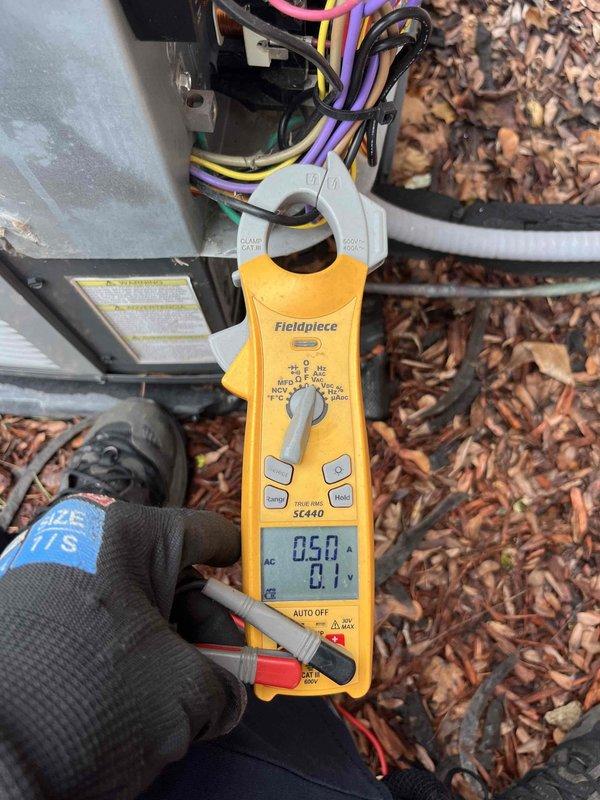 Completed annual air conditioner tune-up on residential AC system. Performed comprehensive electrical diagnostics using clamp meter to verify proper amperage draw and voltage readings on compressor circuit. Inspected dual-run capacitor (35+5 MFD, 440/370VAC rated) for proper operation and terminal connections, verified all wire connections secure at capacitor terminals including compressor and fan motor circuits. System operating within manufacturer specifications, all electrical components functioning properly.