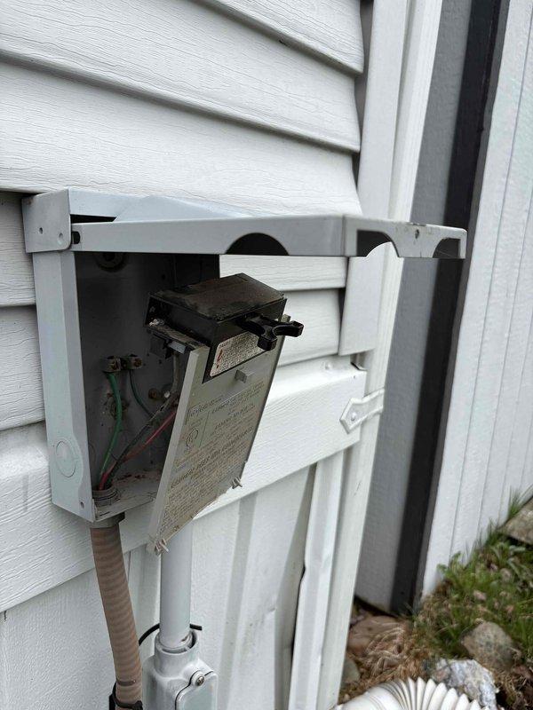 Responded to no-cool call on AC unit that was completely inoperable since customer move-in with suspected wiring issues. Upon arrival, inspected exterior disconnect box and found improper electrical connections with visible wiring concerns. Documented electrical disconnect configuration and internal component condition with photos for service records. Unit age unknown at time of service, requiring further diagnostic evaluation to determine full scope of electrical repairs needed for system restoration.