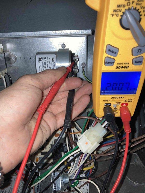 Completed annual AC maintenance tune-up as part of prepaid membership agreement. Performed comprehensive system inspection including blower wheel assembly evaluation, noting normal operational dust accumulation on squirrel cage fan blades and housing. Tested capacitor with digital multimeter to verify proper electrical performance and system functionality, confirming all readings within acceptable parameters for continued reliable operation.