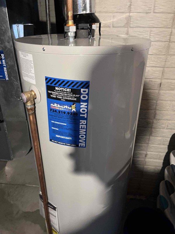 Responded to warranty callback for water heater leak caused by pinhole failure in shut-off valve. Replaced defective shut-off valve with new brass fitting, verified all connections for proper seal, and tested system operation to confirm leak was resolved. Water heater returned to normal operation with no further leakage detected.