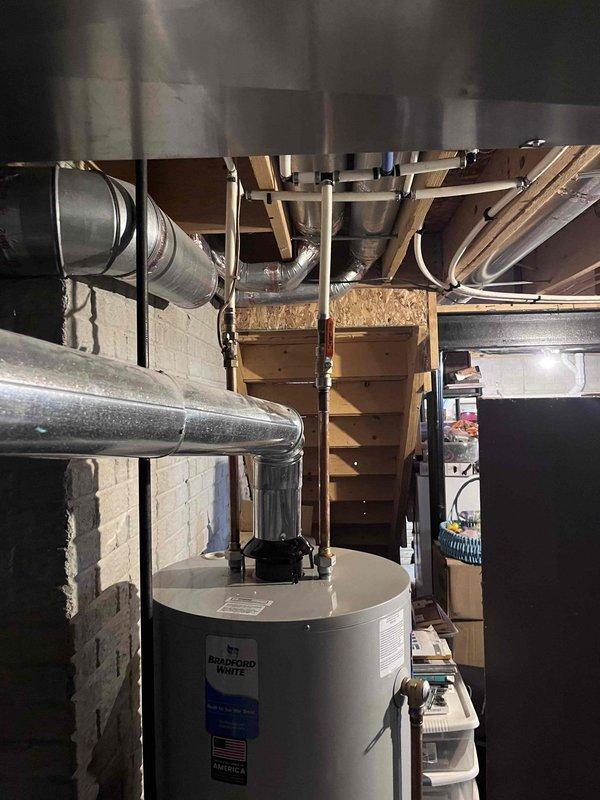 Responded to warranty callback for water heater leak caused by pinhole failure in shut-off valve. Replaced defective shut-off valve with new brass fitting, verified all connections for proper seal, and tested system operation to confirm leak was resolved. Water heater returned to normal operation with no further leakage detected.