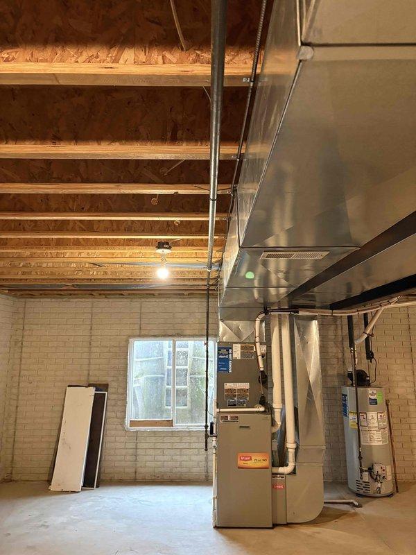 Installed ground fault circuit interrupter (GFI) receptacle in basement utility area to provide code-compliant electrical protection for mechanical equipment zone. The installation ensures proper electrical safety measures are in place for the HVAC system, water heater, and other utilities located in the unfinished basement space.