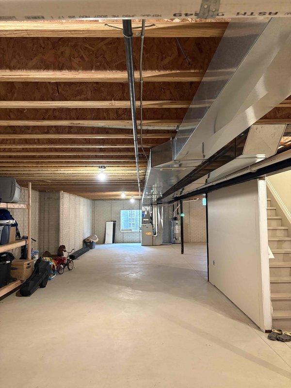 Installed ground fault circuit interrupter (GFI) receptacle in basement utility area to provide code-compliant electrical protection for mechanical equipment zone. The installation ensures proper electrical safety measures are in place for the HVAC system, water heater, and other utilities located in the unfinished basement space.