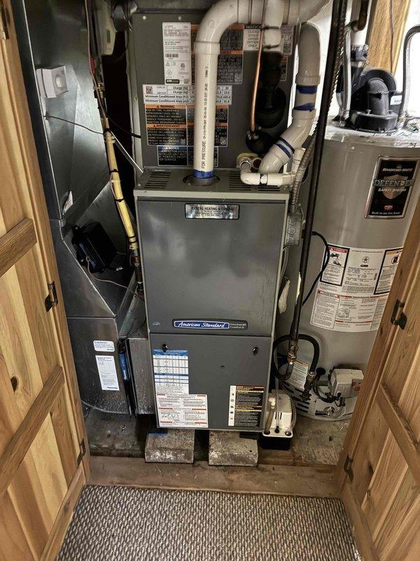 Completed installation of 2-ton air conditioning system with matching evaporator coil in left-side configuration. Performed all mechanical and electrical connections to American Standard furnace system, ensuring proper integration with existing HVAC infrastructure. System was evacuated to proper micron levels as verified by digital micron gauge reading, confirming leak-free installation and removal of moisture and non-condensables from refrigerant lines. All refrigerant connections were brazed and pressure tested, electrical wiring was completed to manufacturer specifications, and condensate drainage was properly routed. Final system startup and operational testing confirmed proper cooling performance and airflow throughout the residence.