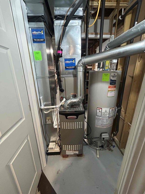Completed full furnace installation including a 70,000 BTU unit with all necessary mechanical and electrical connections in utility closet. Installed and connected ductwork system with metallic and flexible ducts, reconnected all components to existing HVAC infrastructure, and verified proper operation of heating system alongside existing water heater in compact mechanical space.