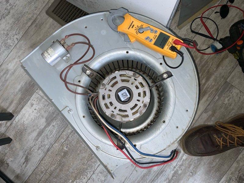 Responded to no cooling complaint on 9-year-old air conditioning system with reported refrigerant smell and uneven airflow distribution throughout residence. Upon arrival, performed diagnostic testing of outdoor unit disconnect and electrical components, revealing issues with contactor assembly. Removed and tested blower motor assembly from air handler unit using multimeter to verify motor capacitor functionality and electrical continuity. Identified failed run capacitor as primary cause of no cooling condition, which was preventing proper blower operation and contributing to unusual odor reported by customer. Replaced defective capacitor, verified proper amperage draw on blower motor, and confirmed system operation. Inspected ductwork accessibility and airflow balance concerns, advising customer on potential damper adjustments needed to address uneven air distribution between zones. System restored to full cooling operation with proper airflow and no abnormal odors detected during fin