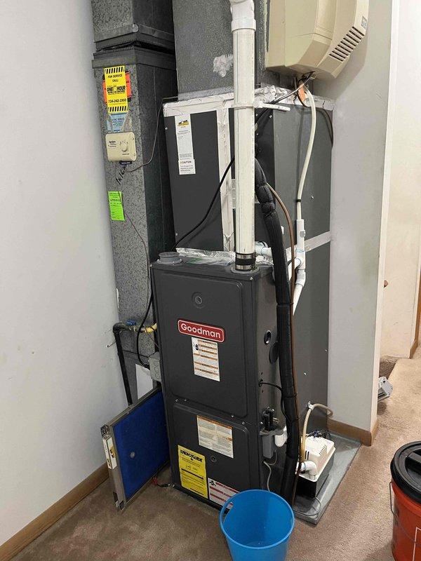 Responded to service call for non-operational upstairs AC unit in a two-unit system. Performed diagnostic inspection of Goodman furnace and associated HVAC components, including examination of control board wiring connections and terminal designations. Inspected electrical connections, condensate drainage system, and verified proper installation of venting components. Documented equipment conditions through photographic records showing furnace unit, control board wiring harness with multiple wire connections to terminal blocks, and overall system configuration for maintenance agreement visit records.