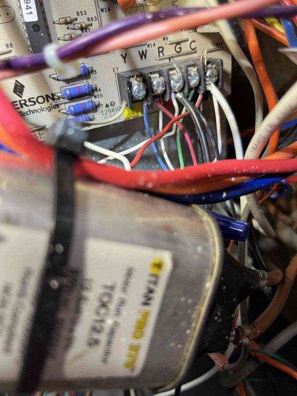Responded to service call for non-operational upstairs AC unit in a two-unit system. Performed diagnostic inspection of Goodman furnace and associated HVAC components, including examination of control board wiring connections and terminal designations. Inspected electrical connections, condensate drainage system, and verified proper installation of venting components. Documented equipment conditions through photographic records showing furnace unit, control board wiring harness with multiple wire connections to terminal blocks, and overall system configuration for maintenance agreement visit records.