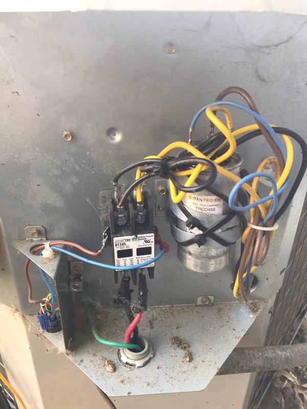Responded to no cooling complaint at residential property. Upon inspection, found failed dual run capacitor preventing compressor and condenser fan motor operation. Replaced defective TRADEPRO capacitor with new TITAN PRO TRCD-455 rated capacitor, verified proper microfarad ratings for both compressor and fan circuits, secured all electrical connections, and tested system operation to confirm cooling restored.
