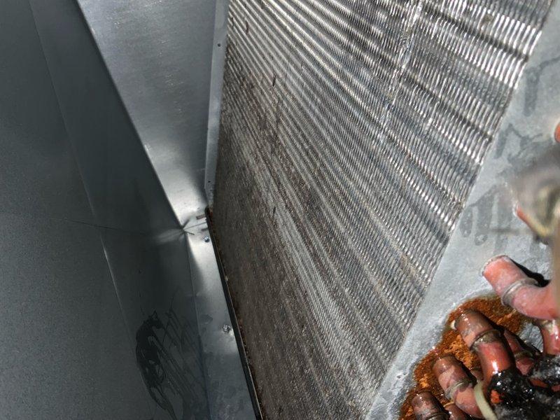 Responded to callback for recently installed AC unit not cooling adequately. Confirmed original diagnosis of failed compressor and inspected system for refrigerant leaks. Leveled outdoor condenser unit with pea gravel to ensure proper operation and drainage. Documented system condition including dirty condenser coil fins with debris accumulation and inspected refrigerant lines, electrical components, and control modules for proper installation and function.