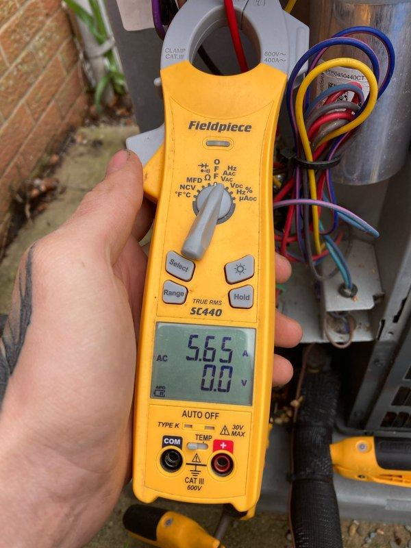 Completed annual air conditioner tune-up as part of prepaid maintenance agreement on a brand new AC system. Performed comprehensive inspection of all system components including motor shaft assembly, fan blade housing, and blower wheel operation. Verified proper electrical performance by measuring amperage draw at 5.65A on compressor unit, confirming system is operating within manufacturer specifications. Inspected all electrical connections, wiring harness, and outdoor condensing unit components for proper installation and functionality. Documented equipment condition through photographic records showing clean motor housing, properly seated fan assembly, and secure electrical connections at outdoor unit. System found to be in excellent operating condition with no deficiencies noted.