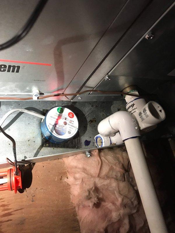 # HVAC Service Report - Unico System Insufficient Cooling

Responded to service call for Unico high-velocity air conditioning system not maintaining adequate cooling capacity. Upon arrival, performed visual inspection of air handling unit and evaporator coil assembly. Found significant dust and debris accumulation on evaporator coil fins, with visible brownish discoloration along bottom edge indicating restricted airflow and reduced heat transfer efficiency. Coil contamination was impacting system performance and preventing unit from achieving desired temperature setpoint.

Documented existing conditions with photographs showing extent of coil fouling and overall system condition. Evaporator coil displayed heavy buildup throughout fin surfaces, which restricts airflow across coil and diminishes cooling capacity. Copper refrigerant lines and surrounding components inspected and found intact with no visible damage or refrigerant leaks.

Recommended thorough coil cleaning to restore prope