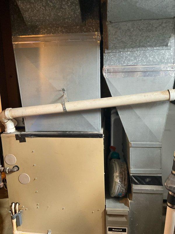 Conducted on-site evaluation of existing 80% efficiency furnace installation in basement of small two-story residence with no current central air conditioning system. Assessed existing ductwork, electrical service, gas line configuration, and available space for potential air conditioning component integration. Documented current HVAC system configuration including furnace cabinet, supply and return ductwork, PVC condensate drain lines, and gas piping to provide comprehensive replacement options for both 80% and 90% efficiency furnace units with complete central air conditioning systems.