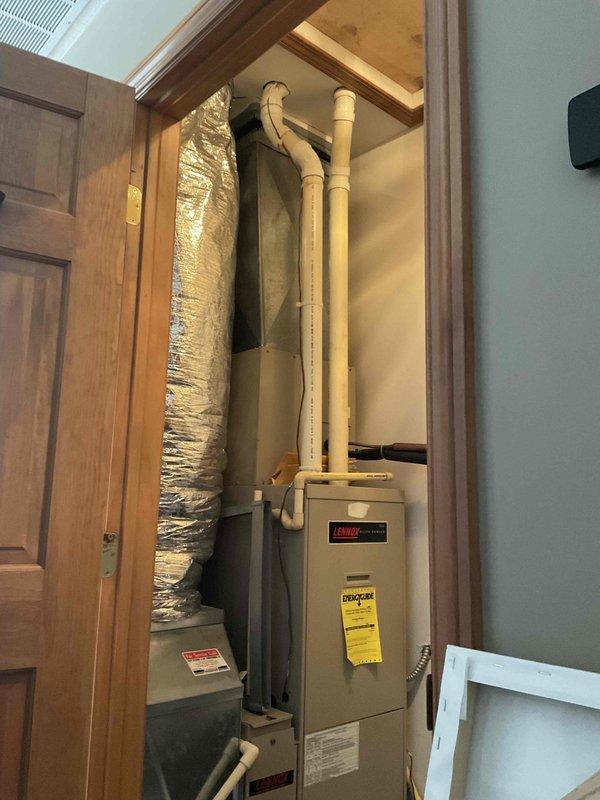Completed comprehensive HVAC system replacement estimate for residential property, evaluating existing Bryant furnace installation within utility closet configuration and assessing exterior condenser placement options. Documentation included interior equipment positioning with vertical PVC venting and flexible ductwork routing, along with exterior foundation area evaluation for optimal condenser unit placement considering landscaping and accessibility requirements.