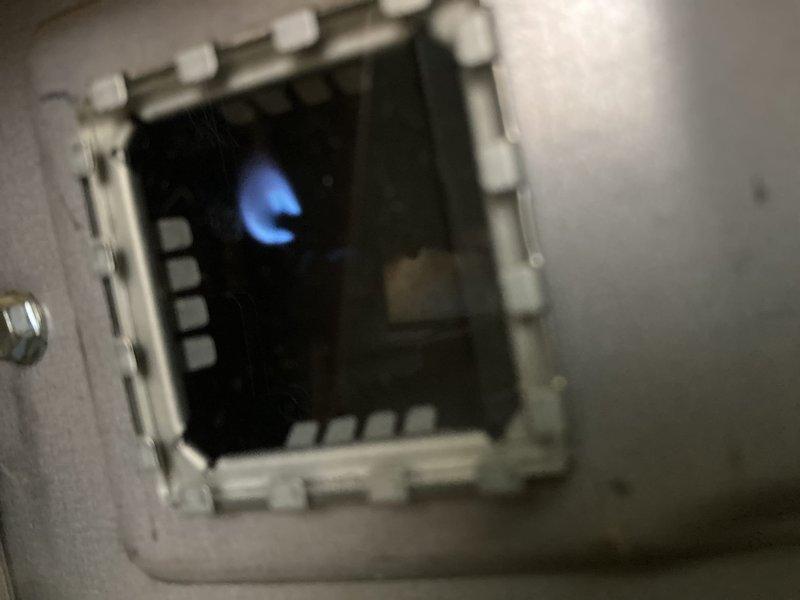 Responded to no-ignition complaint on tanked water heater. Upon inspection, found pilot light extinguished and burner assembly not firing. Successfully relit pilot light and verified main burner ignition sequence, confirming unit returned to proper operation with stable blue flame combustion.