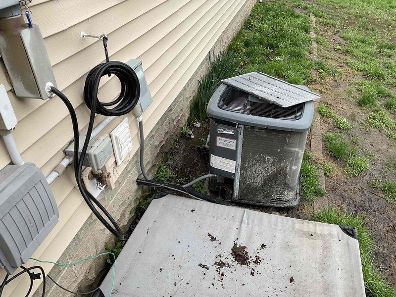 Conducted on-site assessment for mini split system installation to replace failed air conditioning compressor unit. Evaluated existing HVAC infrastructure including furnace, water heater, and outdoor condenser unit located on concrete pad adjacent to building foundation. Documented current equipment conditions, utility connections, electrical disconnect box, and PVC piping configuration to determine optimal placement and specifications for new mini split system installation.