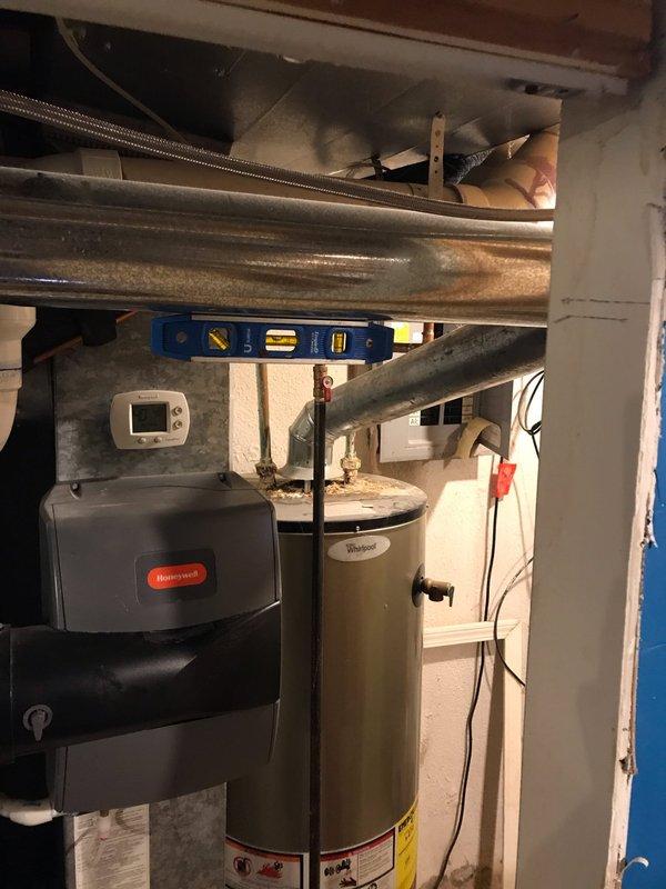 Responded to no heat call on 5-year-old furnace system. Upon arrival, performed diagnostic inspection of heating equipment and associated components. Visual inspection revealed significant rust and corrosion at the furnace vent pipe connection point, with extensive deterioration around the base and flue elbow joint. The corrosion had compromised the integrity of the venting system, creating a potential safety hazard and contributing to improper system operation. 

Evaluated the Honeywell heating unit and verified thermostat operation. Documented the condition of the corroded vent pipe assembly and surrounding areas with photographs for service records. The rust accumulation and degraded gasket at the connection point indicated moisture infiltration and possible condensation issues affecting the venting system. Advised that the deteriorated vent pipe components require replacement to restore safe and proper furnace operation. System was left in safe condition pending necessary repairs t