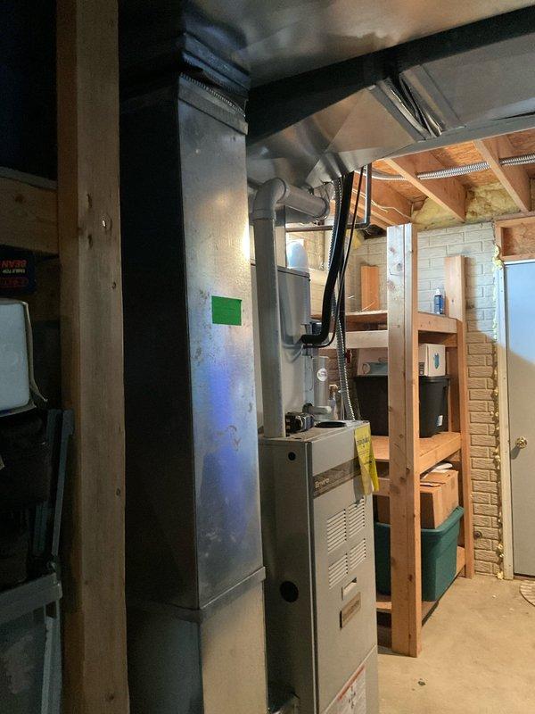 Conducted comprehensive site evaluation for complete HVAC system replacement. Assessed existing outdoor condensing unit positioned on decorative stone bed against exterior wall and indoor furnace installation in basement utility area with exposed framing. Documented current equipment configuration, electrical connections, ductwork routing through ceiling joists, and clearance requirements for replacement unit specifications. Provided detailed estimate for new system installation including equipment removal, proper sizing recommendations, and installation requirements based on existing infrastructure and space constraints.