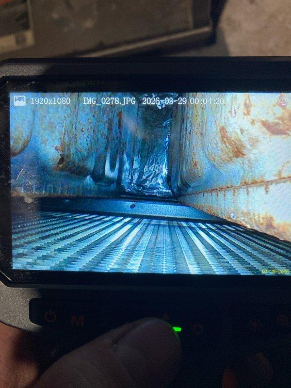 Responded to maintenance call for air conditioning system not cooling. Upon inspection, discovered severe corrosion and deterioration within the heat exchanger, exhibiting extensive rust patterns and water damage indicating prolonged moisture exposure. Documented compromised ductwork in crawl space showing significant corrosion, torn insulation, and deteriorated protective coating. System deemed unsafe for operation due to heat exchanger failure presenting potential carbon monoxide hazard. Recommended immediate system replacement and advised customer to discontinue use until new unit installed.