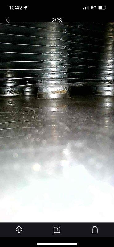 Completed comprehensive heating and cooling system tune-up on residential HVAC unit. Inspected evaporator coil assembly, noting normal condensation patterns and minor surface discoloration on fins. Examined ductwork system, observing typical wear and minor moisture accumulation on flexible ducting. System operating within normal parameters with no immediate service needs identified.
