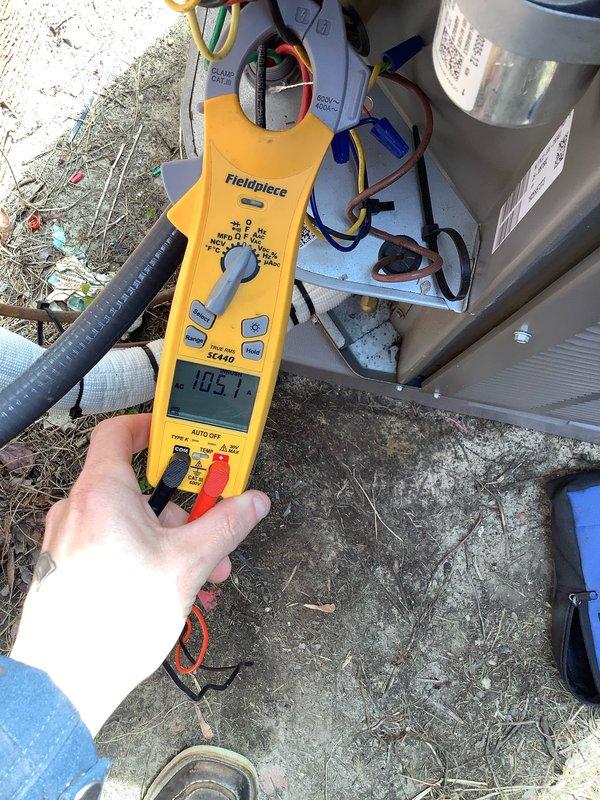 Completed prepaid AC maintenance tune-up on residential air conditioning system. Performed comprehensive inspection of indoor and outdoor units, including blower access compartment verification and electrical performance testing. Measured system amperage at 108.1 amps using clamp meter to verify proper compressor and motor operation within manufacturer specifications. Documented equipment condition and component identification labels for maintenance records.