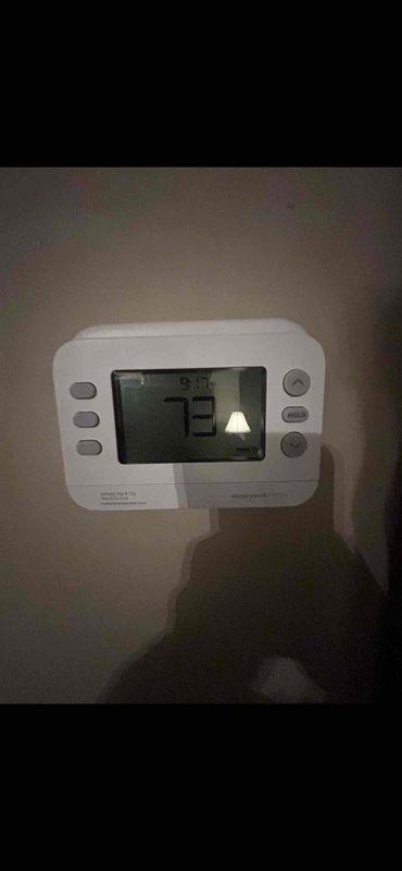 Completed installation of 2.5 ton air conditioning unit with matching evaporator coil in rear location. Reconnected all mechanical and electrical components, tested system operation, and verified proper thermostat functionality showing accurate temperature readings.