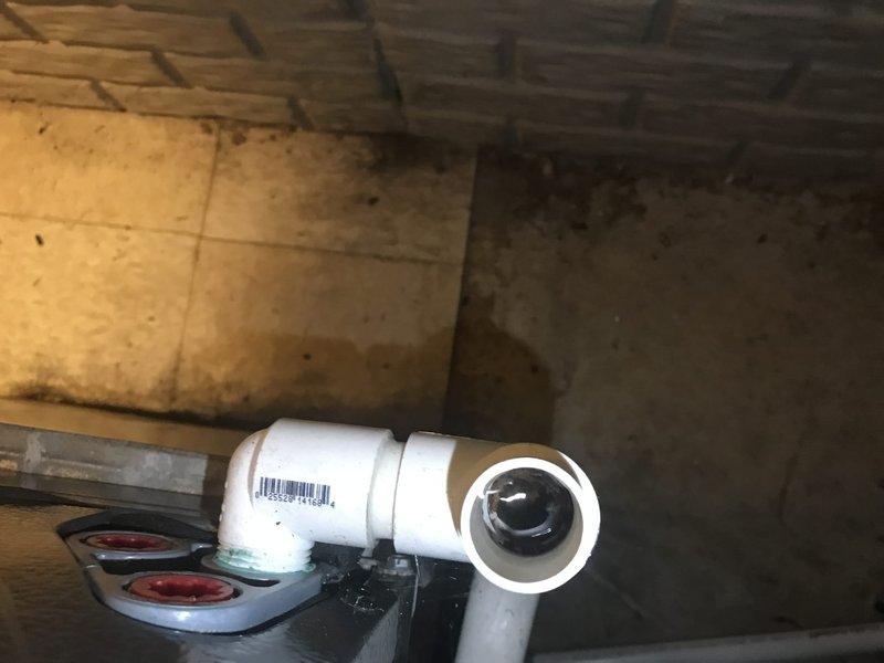 Completed prepaid air conditioning maintenance tune-up during scheduled morning service window. Performed comprehensive system inspection and standard maintenance procedures on residential AC unit. Documented plumbing components and condensate drain line configuration in utility area, noting PVC drainage assembly with proper connections and functional condition.