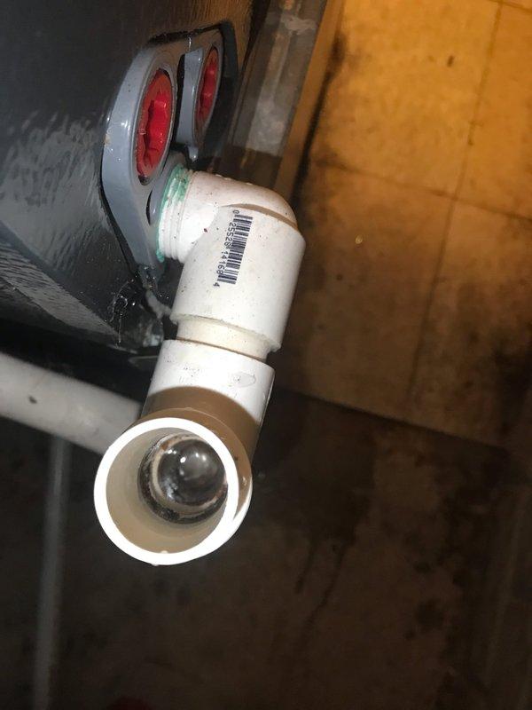 Completed prepaid air conditioning maintenance tune-up during scheduled morning service window. Performed comprehensive system inspection and standard maintenance procedures on residential AC unit. Documented plumbing components and condensate drain line configuration in utility area, noting PVC drainage assembly with proper connections and functional condition.