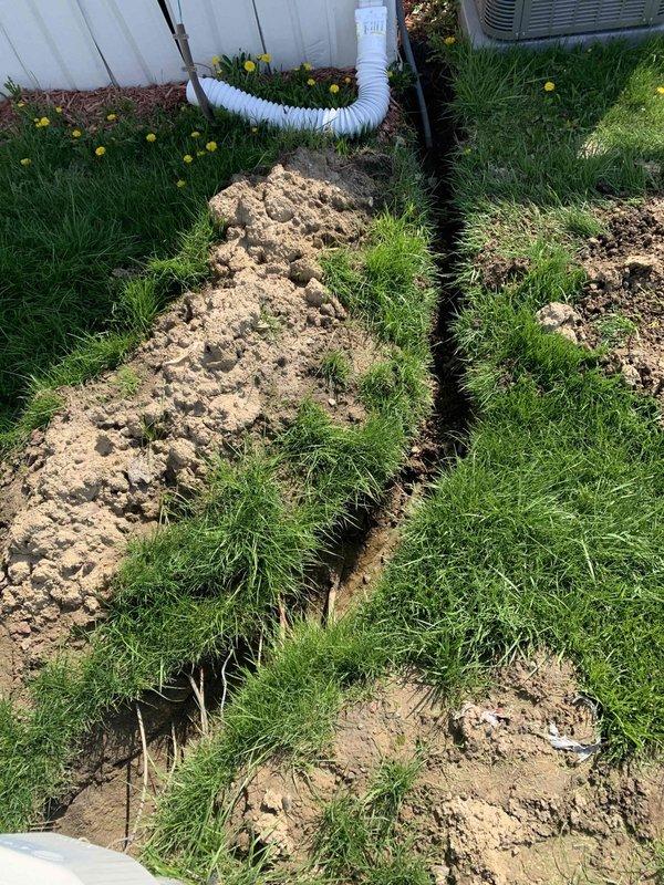 Responded to callback regarding excavation from recent AC installation that extended into adjacent property. Backfilled trench with soil, compacted material, and covered disturbed area with wood chips to match surrounding landscape. Verified HVAC condenser unit remained properly positioned and all associated ductwork connections were secure following remediation work.