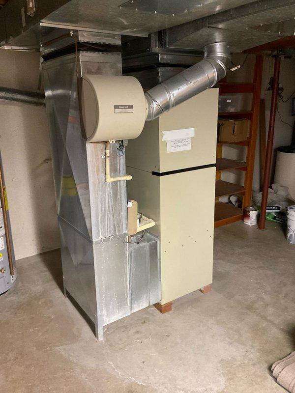 Conducted on-site evaluation of aging HVAC system including furnace and air conditioning components. The existing Plus 80 furnace and AC unit showed signs of advanced wear, with the air conditioning system producing abnormal operational noises indicating potential compressor or fan motor issues. Performed comprehensive assessment of both heating and cooling equipment, documented current system configuration including ductwork connections and humidifier integration, and photographed equipment for replacement estimate preparation. Provided detailed replacement options for complete HVAC system upgrade to prevent imminent failure.