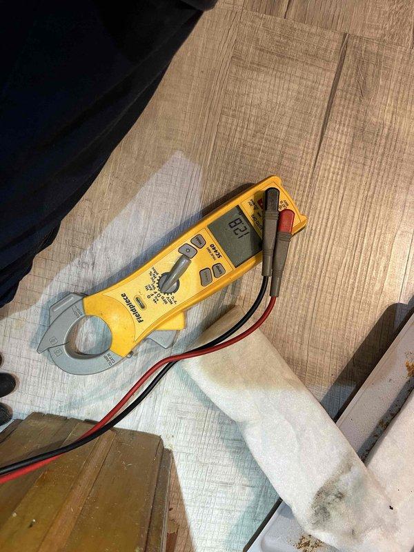 Responded to service call for club air conditioning unit and water heater producing noise and failing to deliver hot water. Upon arrival, performed diagnostic testing using clamp meter and multimeter to assess electrical components and system performance. Identified operational issues affecting both HVAC and water heating systems. Conducted thorough inspection of equipment, documented existing conditions including wall damage near installation area, and recorded amperage readings during system operation. Completed maintenance agreement visit with full system evaluation and diagnostic measurements.
