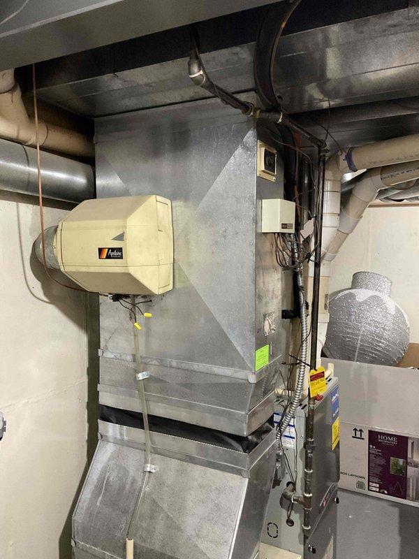 Conducted on-site evaluation of a 10-year-old Trane furnace system with a failed heat exchanger. Documented existing equipment configuration including Honeywell control module, humidifier unit, and ductwork system through photographic assessment. Prepared single component replacement estimate for furnace unit only.