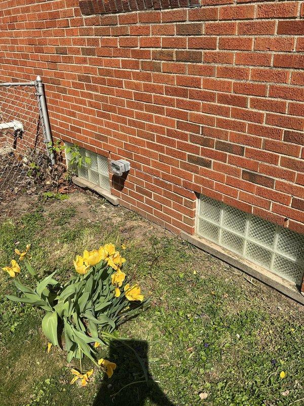 Installed ground fault circuit interrupter (GFI) outlet at exterior location on brick foundation wall near HVAC condenser unit. Ensured proper weatherproof enclosure and verified correct wiring connections for outdoor electrical safety compliance.
