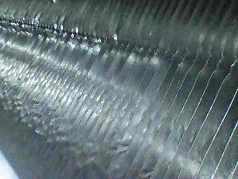 Completed comprehensive AC tune-up and maintenance inspection per agreement service. Inspected evaporator and condenser coils, noting moderate dust and debris accumulation between fins with visible discoloration and streaking on heat exchanger surfaces. Performed standard maintenance procedures including filter check, refrigerant level verification, electrical connection inspection, and system operational testing to ensure proper cooling performance for the season.