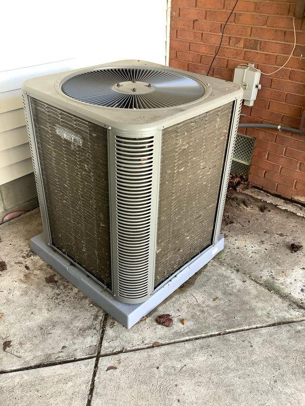 Completed pre-season air conditioning tune-up on a two-year-old residential AC system. Performed comprehensive inspection of outdoor condenser unit, which showed normal weathering and surface accumulation consistent with age. Cleaned condenser coils and exterior panels to remove dirt, debris, and organic growth from louvered grilles. Verified proper operation of condenser fan and checked electrical connections at disconnect box. Inspected condensing pad for stability and drainage. Measured refrigerant pressures and confirmed system is operating within manufacturer specifications. All components functioning properly with no immediate repairs required. System is ready for cooling season operation.