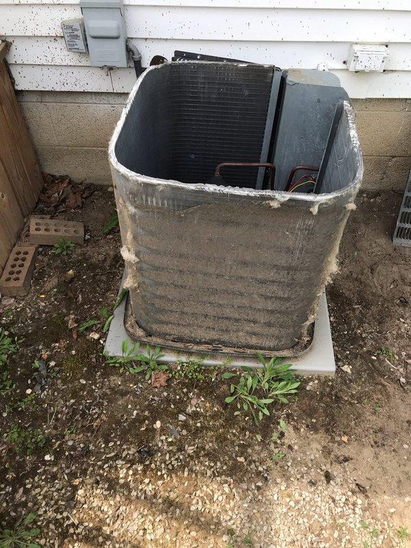 Completed scheduled CLUB AC 12-4 maintenance agreement visit on multiple outdoor condensing units. Upon arrival, found equipment and heat exchanger coils heavily soiled with thick layers of dirt, dust, and debris accumulation on finned surfaces. Concrete pad showed significant weathering with vegetation growth and staining. Exterior metal casing displayed extensive grime buildup and discoloration from prolonged exposure to outdoor elements.

Performed comprehensive visual inspection of all condensing units positioned on concrete pad. Assessed condition of finned coil sections, noting substantial dirt coating affecting airflow efficiency. Examined copper tubing, refrigerant lines, and condensate drainage system. White PVC condensate line showed brown discoloration and dirt streaks but remained structurally sound. Verified electrical disconnect box and service panel condition. Checked concrete pad foundation for structural integrity and proper equipment leveling.

Documented equipment co