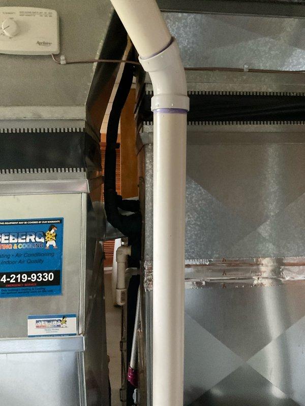 Performed estimate for HVAC system replacement on R22 unit found to be low on refrigerant charge. Evaluated existing indoor furnace/air handler unit in basement utility area and outdoor condensing unit positioned at exterior brick wall. Documented current system configuration including condensate drainage, electrical disconnect, and overall equipment condition to provide replacement options for aging R22 system.