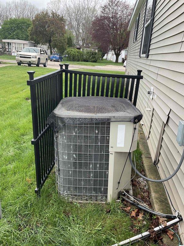 Provided comprehensive estimate for complete HVAC system replacement including both furnace and air conditioning condenser unit, both original equipment dating from 2007. Assessed existing outdoor condensing unit positioned against exterior wall with protective fencing and evaluated current refrigerant line set configuration. Documented equipment specifications and existing installation conditions to prepare detailed replacement proposal for aging residential heating and cooling system.