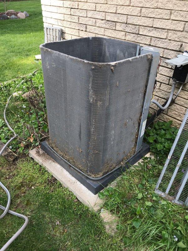 Completed scheduled CLUB AC 8-12 maintenance agreement visit on residential air conditioning system. Performed comprehensive inspection of outdoor condenser unit, noting significant accumulation of dirt, debris, and environmental weathering on exterior surfaces and mesh panels. Documented equipment condition through photographic records showing unit positioned on concrete pad with proper clearances, though vegetation growth near base was observed. Conducted standard preventive maintenance procedures including visual inspection of refrigerant lines, electrical connections, and overall system integrity to ensure continued reliable operation throughout cooling season.