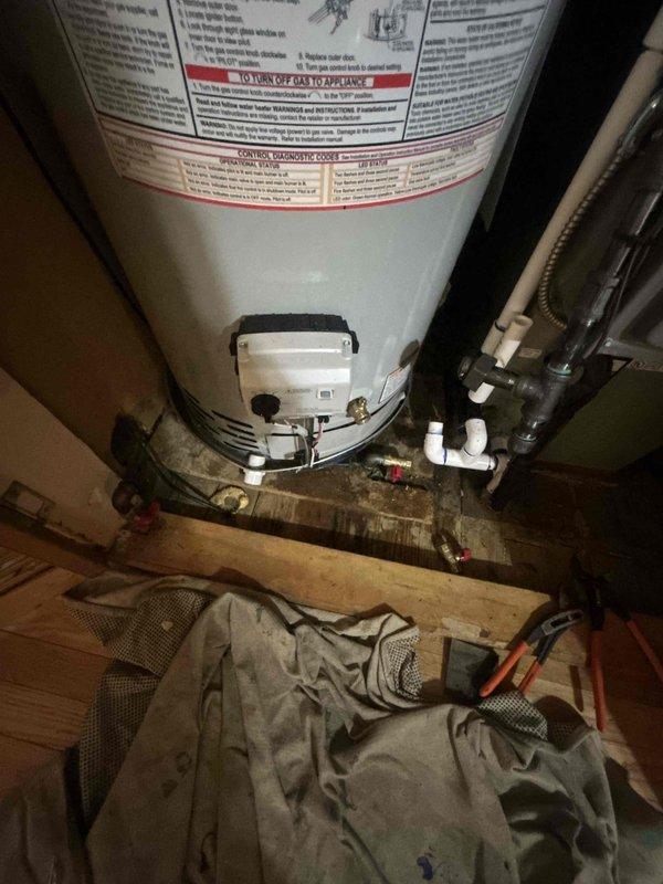 Completed callback service to address water heater installation deficiencies. Installed drain pan underneath water heater unit to provide secondary containment protection and prevent potential water damage to surrounding area. Removed existing temperature and pressure relief valve discharge tube and replaced with copper piping, properly routing discharge line into newly installed drain pan per code requirements.