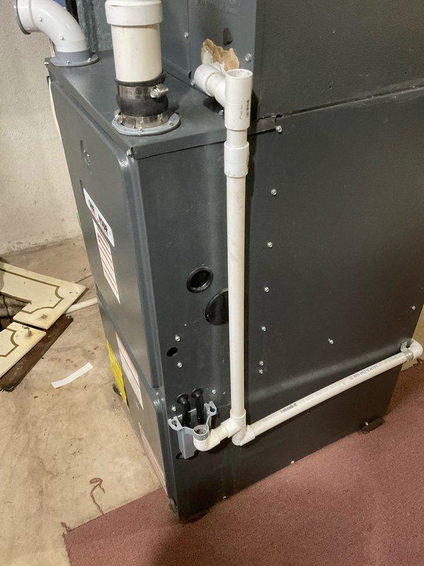 Performed diagnostic evaluation on 16-year-old HVAC system and discovered condenser unit completely void of refrigerant, indicating significant system failure. Provided comprehensive estimate options comparing repair versus full system replacement, explaining that repair would require refrigerant recharge and extensive leak detection process with no guarantee of successful repair due to age and condition of equipment. Recommended complete system replacement as most cost-effective solution given the unit's age and potential for additional component failures. Documented existing furnace and air handler configuration with connected ductwork and PVC condensate piping for replacement specifications.