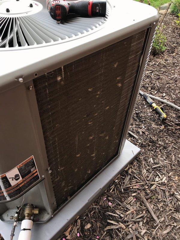 Completed annual AC maintenance tune-up on residential air conditioning system. Condenser unit showed significant dirt and debris accumulation on coil fins, which was cleaned to restore proper airflow and heat transfer efficiency. System inspected, serviced, and documented with photos showing before and after condition of outdoor unit.