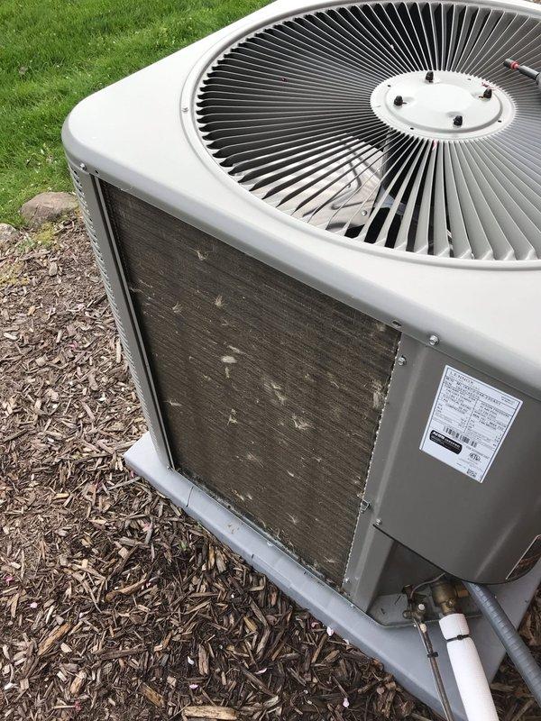 Completed annual AC maintenance tune-up on residential air conditioning system. Condenser unit showed significant dirt and debris accumulation on coil fins, which was cleaned to restore proper airflow and heat transfer efficiency. System inspected, serviced, and documented with photos showing before and after condition of outdoor unit.