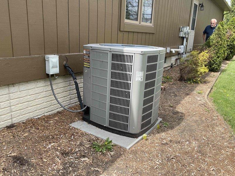 Completed on-site estimate for HVAC system replacement at residential property. Documented existing outdoor condensing unit and electrical service panel configuration, recorded equipment model and serial numbers from the air conditioning unit, and assessed electrical disconnect and circuit breaker setup to determine replacement specifications and compatibility requirements.