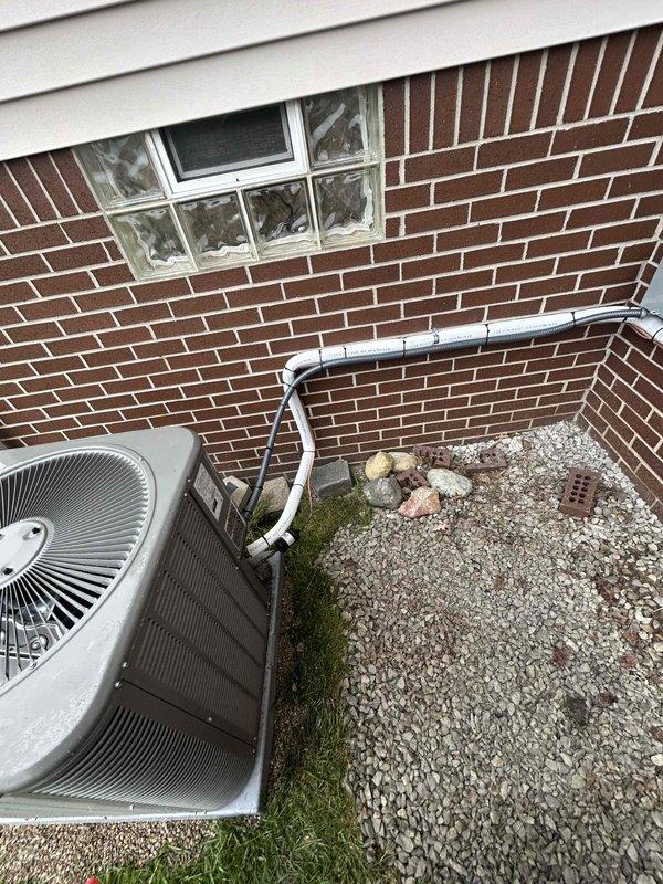 Completed callback service to relocate AC condenser unit away from generator to ensure proper clearances and code compliance. Installed additional lineset to accommodate new equipment position, secured unit on fresh pea gravel base, and verified all refrigerant connections and condensate drainage lines are functioning properly per manufacturer specifications.
