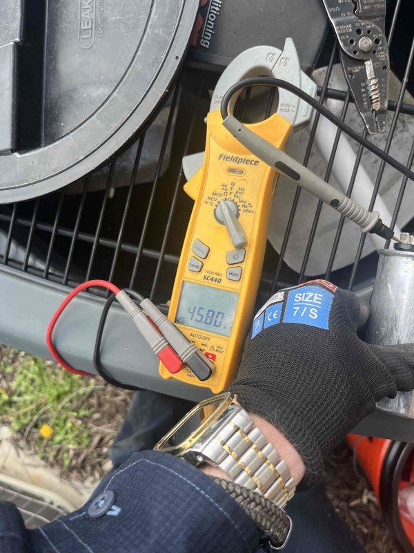Completed routine furnace and air conditioning maintenance club visit, performing comprehensive system diagnostics on both heating and cooling equipment. Used digital clamp meter to verify electrical current readings on the Lennox outdoor condensing unit, measuring amperage at 15.88 amps on one component and 1.15 amps on another circuit, confirming proper electrical operation within manufacturer specifications. Inspected condenser coils, fan motor operation, and overall unit condition. Tested indoor heating system components, checking electrical connections and verifying proper amperage draws on furnace circuits. All systems operating correctly with no deficiencies noted. Both heating and cooling equipment passed inspection and are functioning as designed for the seasonal maintenance agreement visit.