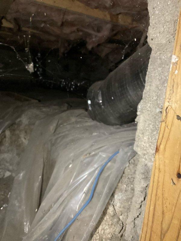 Responded to service call for non-functional air conditioning system that had exceeded its operational lifespan at over twenty years of age. Conducted comprehensive assessment of existing HVAC equipment, including inspection of air handler unit, ductwork configuration, and refrigerant line connections in mechanical space. Documented current system conditions through photographic evidence, capturing deteriorated components showing significant dust accumulation and age-related wear on metal surfaces and insulation materials. Evaluated attic installation area, noting existing flexible ductwork with insulation, vapor barrier materials, and structural framing to determine replacement feasibility and access requirements. Prepared two detailed replacement quotes (03665-01 and 03665-02) outlining equipment options and installation specifications for new air conditioning system to address complete system failure of aged unit.