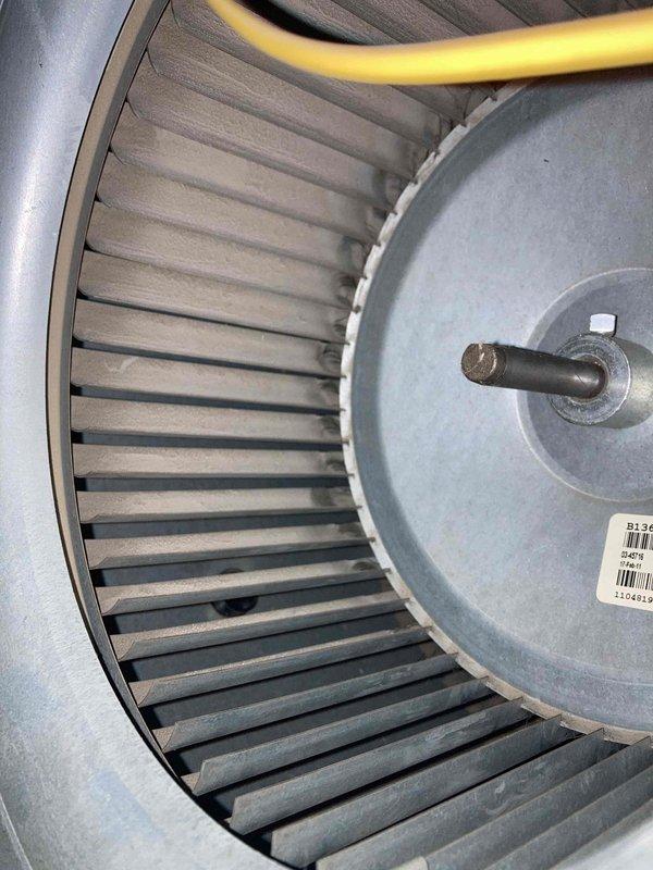 Completed preventative maintenance inspection under Club AC8-12 agreement. Inspected blower wheel assembly and motor, noting moderate dust accumulation on fins consistent with normal operational use. Documented equipment condition including motor housing and electrical connections. All components found to be in serviceable condition with no immediate repairs required.