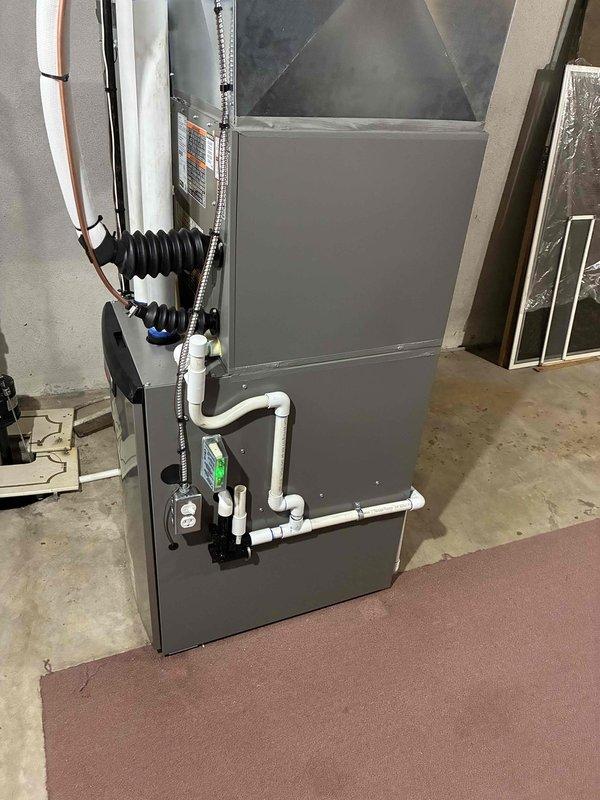 # Complete HVAC System Installation

Successfully completed a full residential HVAC system installation including a 70,000 BTU gas furnace, 2-ton air conditioning unit with rear discharge configuration, and whole-home humidifier. Performed all mechanical and electrical connections per manufacturer specifications and local code requirements.

## Equipment Installed

- Crosswind brand furnace unit with 70,000 BTU heating capacity
- 2-ton central air conditioning system configured for rear discharge
- Whole-home humidifier integrated with heating system
- Complete ductwork connections and transitions

## Work Performed

Installed new furnace unit in basement mechanical room with proper clearances and ventilation. Mounted air handler vertically and connected refrigerant lines with appropriate insulation and vibration dampeners. Ran copper refrigerant piping from outdoor condensing unit to indoor air handler with proper line sets. Installed flexible metal conduit for electrical connections.
