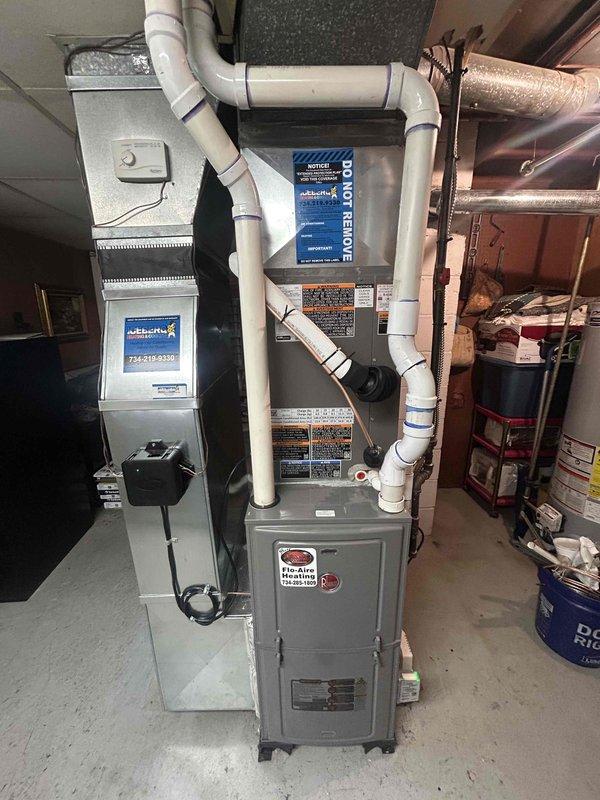 Completed installation of 3-ton air conditioning system with matching evaporator coil on existing furnace unit in basement utility area. Connected refrigerant lines, installed proper venting with PVC piping, and verified electrical connections to ensure system operates within manufacturer specifications. System tested and operational with appropriate condensation visible on ductwork, confirming proper cooling function.
